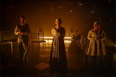 Jimmy Morgan as Gardener, Rachel Rhea Shannon as Housekeeper and Monica Mendez as Kitchen Maid (foreground) Matenin Sangara as Mary (background)